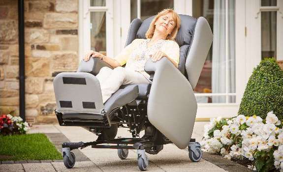 Elderly woman relaxing in a reclining chair