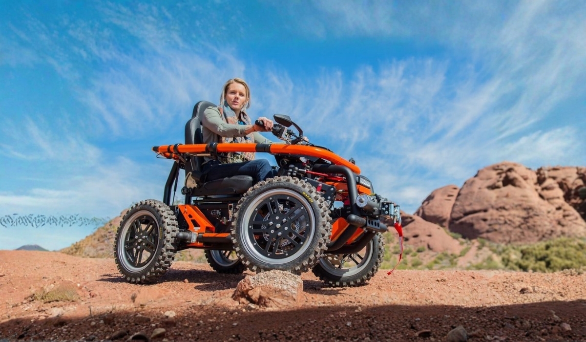 All-terrain electric wheelchair riding through the desert