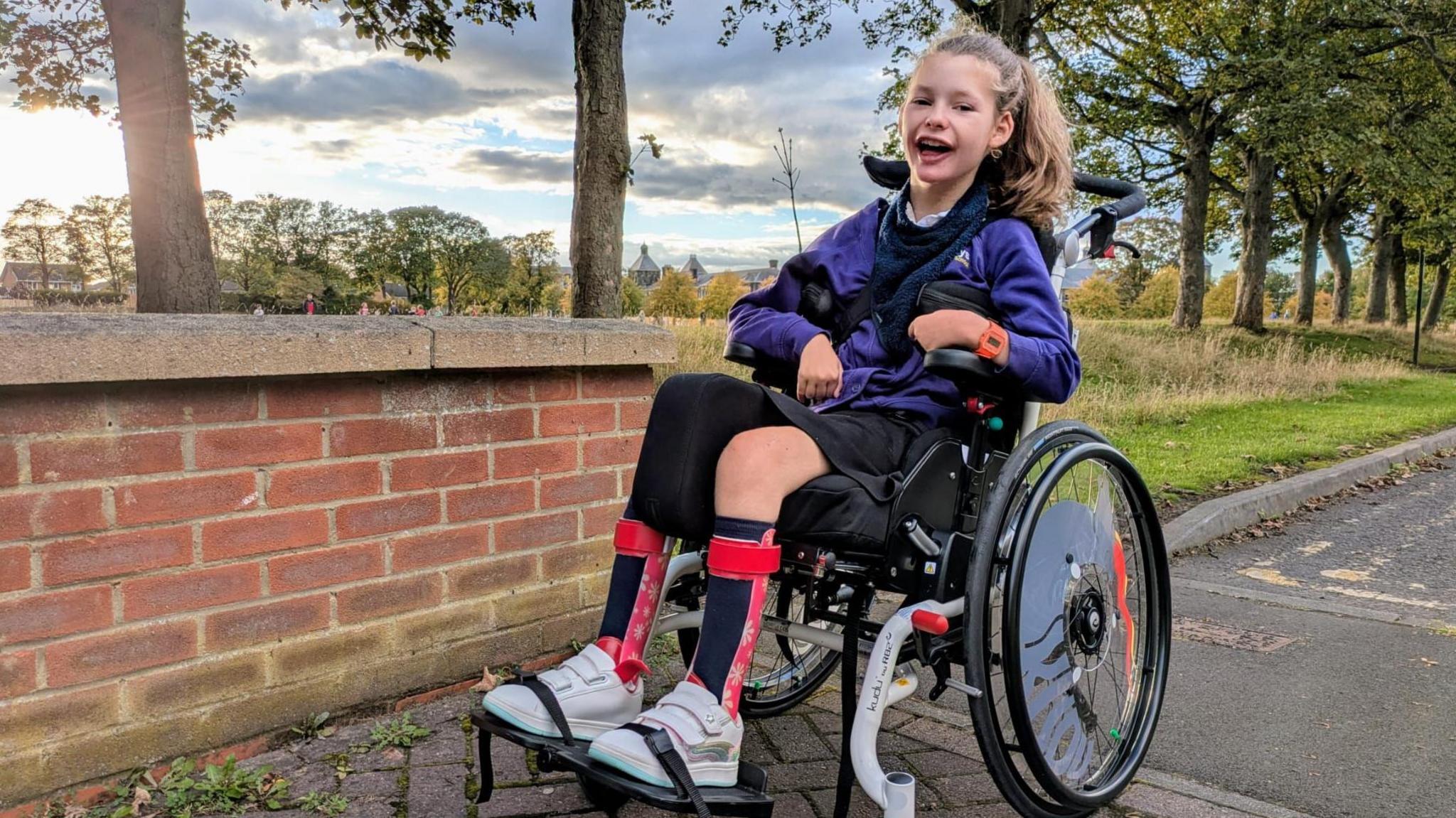 Smiling girl in a wheelchair