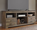 Trinell - 63" TV Stand With Glass/Stone Fireplace Insert - Brown