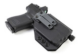 Black Kydex IWB holster angled view with Glock 19 holstered, showing belt clip and mounted red dot optic
