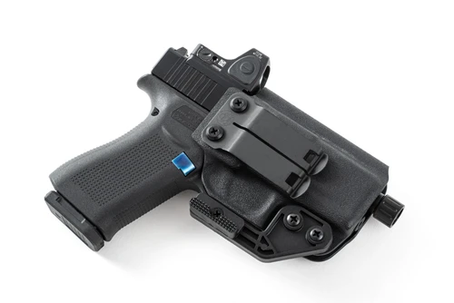 Black Kydex IWB holster with Glock 43x holstered, red dot optic, belt clip and attached claw wing, angled view