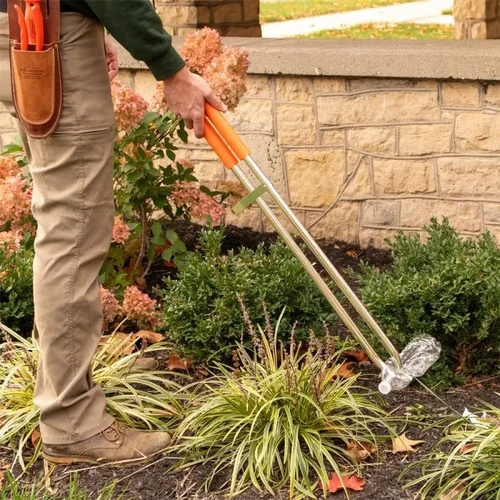 Reacher picking bottle from grass