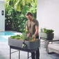 man planting in Hooks for Nest Raised Planter