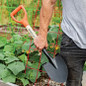 Shovel carried beside garden bed