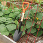 Shovel in raised garden bed