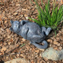 Playful Cats Laying on Back Statue in the Garden