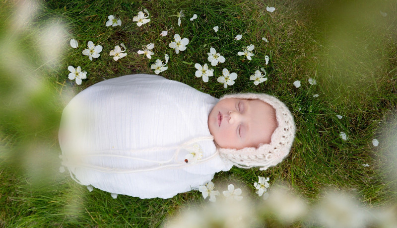 newborn-baby-with-white-flowers.jpg