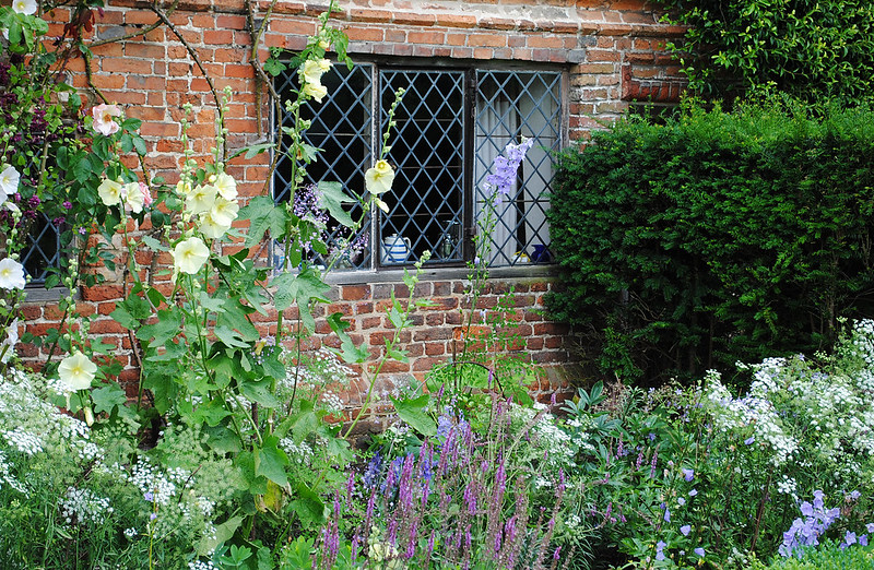 sissinghurst-featuring-hollyhocks-salvia-roses-bellflower-baby-s-breath-and-boxwood.jpg