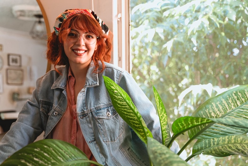 smiling-woman-next-to-dieffenbachia-in-indirect-light.jpg