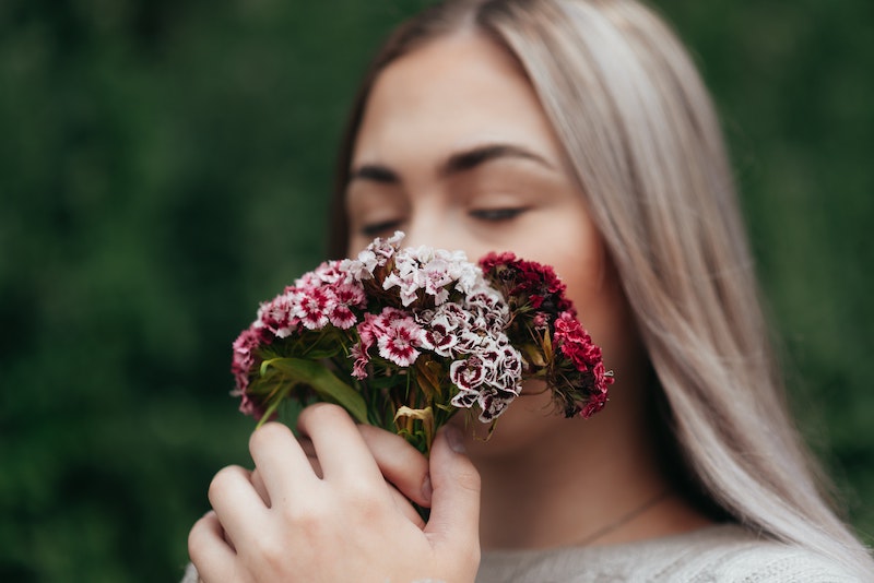 woman-sniffing-a-bouquet-of-dianthus.jpg