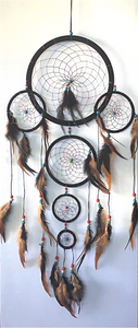 Dream catchers are one of the most fascinating traditions of Native Americans.
This handmade dream catcher is intended to protect the sleeping individual from negative dreams while letting positive dreams through. The positive dreams will slip through the center of the dream catcher, and glide down the feathers to the sleeping person below. The negative dreams will get caught up in the web, and expire when the first rays of the sun strike them.
Measurements: Top ring is 11" diameter, length is approximately 32".
Dimensions will vary slightly due to the handmade nature of this product. Dream catchers are one of the most fascinating traditions of Native Americans.
This handmade dream catcher is intended to protect the sleeping individual from negative dreams while letting positive dreams through. The positive dreams will slip through the center of the dream catcher, and glide down the feathers to the sleeping person below. The negative dreams will get caught up in the web, and expire when the first rays of the sun strike them.
Measurements: Top ring is 11" diameter, length is approximately 32".
Dimensions will vary slightly due to the handmade nature of this product.