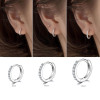 Gold tone zirconia huggie earrings detail