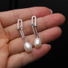 White pearl drop earrings detail