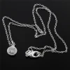 Silver tone floral pendant necklace detail