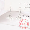 Silver tone pearl huggie earrings product view