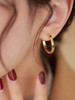 Gold tone round huggie earrings product view