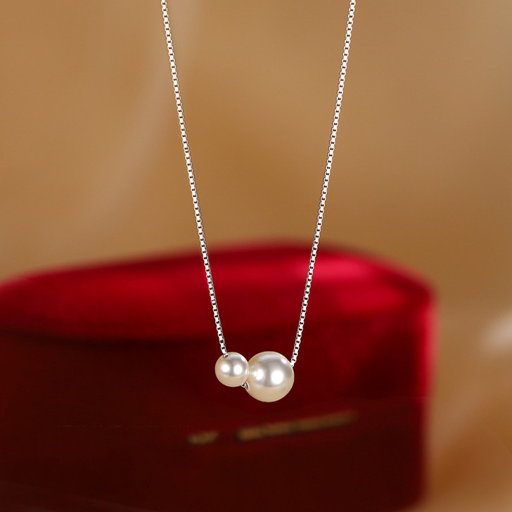 Silver tone two pearl necklace detail