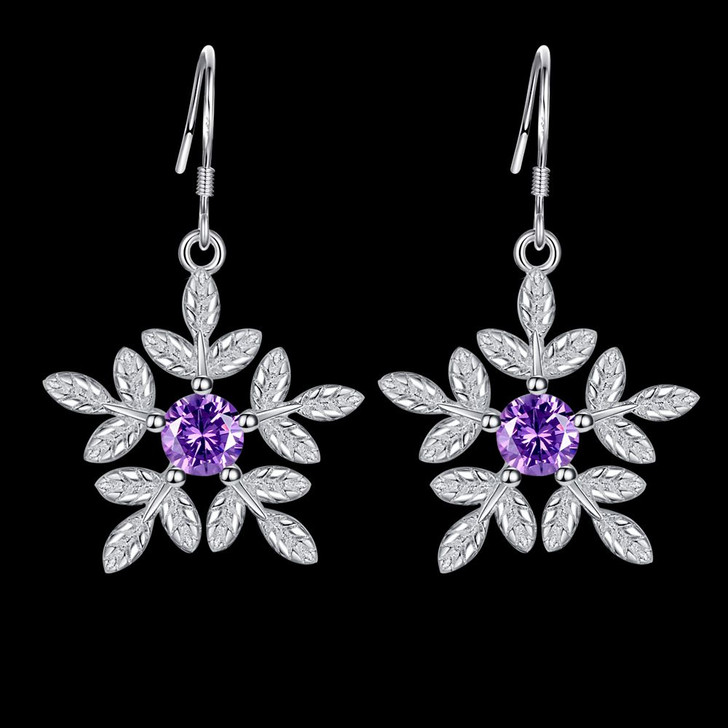 Silver tone purple zircon flower earrings on black background