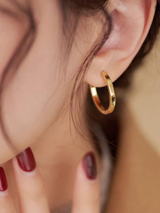 Gold tone round huggie earrings product view