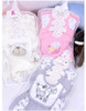 Generic White Sheep 8-Piece Layette Set, including various baby clothes with cute animal and ice cream prints, wrapped in clear plastic packaging.