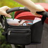 Joyren Black Neoprene Milk Bag Hang on Stroller, attached to a stroller handle, storing a milk bottle, a plush toy, and other baby essentials.