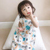 Karitree Four Layer Jungle Sleeveless Sleeping Bag, kids sleeping bag with jungle animal print, baby girl sitting on white sleeping bag on beige carpet, casual sleepwear for children.