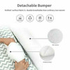 OONA Grey & White Crown Nest Bed for Bed Co sleep Bed, close-up of the breathable, non-woven, knitted surface fabric with a person holding the bed.