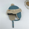 Generic Winter Hat With Brown Lamb Ear Flaps, blue winter hat with cream-colored faux shearling lining and ear flaps, designed for warmth and comfort in cold weather.