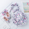 Generic Easter Egg Backless Romper Set, featuring a sleeveless romper with unicorn and Easter egg pattern and a matching bow headband, displayed on a white grid background with a beach photo and a smiley face card.