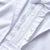 White Tuxedo Boy Cotton Romper, close-up of the detailed front with ruffles, buttons, and bow tie.