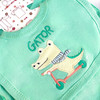Generic Alligator Layette Set 8 Piece, light green baby bib with embroidered alligator riding a scooter and the word 'GATOR' on it.