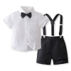 OONA Mike Short Suite Suspender, a children's formal outfit consisting of a white short-sleeve shirt with a black polka dot bow tie and black shorts with attached suspenders.