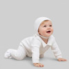 Minnie Me Noah Christening Romper, baby crawling in white christening romper with hat, cute infant wear for special occasions.