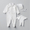 Minnie Me Austin Silver Cross Embroidery Set, white embroidery set includes a long-sleeved jumpsuit, a bonnet, and a smaller outfit for a baby.
