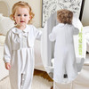 Minnie Me Nash Christening Romper, adorable toddler girl wearing a white christening romper with a bow collar and button details, front view and back view on a child in a cozy home setting.