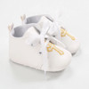 Minnie Me Gold Cross Infant Baptism 5pcs Set, a pair of white infant shoes with gold embroidered cross, white laces, and soft interior lining.