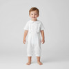 Minnie Me Eric Baby Boy Christening Romper Set, adorable young boy wearing a white christening romper with short sleeves, button details, and a rounded collar, suitable for a special occasion.