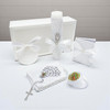 Minnie Me White 5 PCS Baptism Kit, religious baptism accessories including candle, rosary, prayer booklet, shell, and keepsake items arranged on a white surface with a white box in the background.