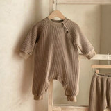 Generic Knitted Round Neck Bodysuit, beige ribbed knit infant onesie with long sleeves and snap button closure at the shoulder.