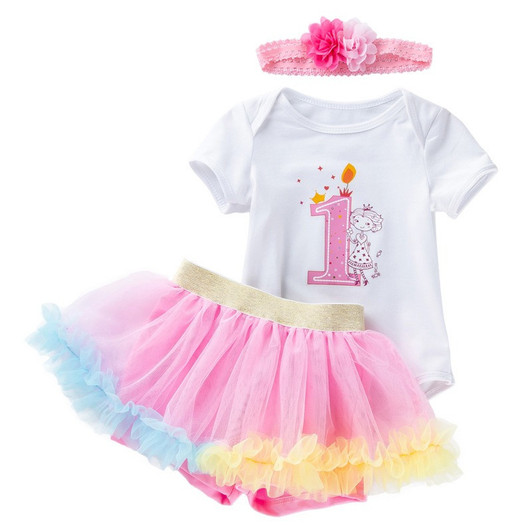 Generic Short Sleeve Romper Tutu Skirt Headband, Baby girl's birthday outfit consisting of a white short sleeve romper with a pink number one and princess print, a pink tutu skirt with yellow and blue ruffle trim, and a pink headband with fabric flower embellishments.