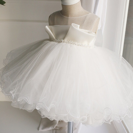 OONA Emma Tulle Bouffant, white baby dress with satin bodice and voluminous tulle skirt with delicate swirl embroidery.