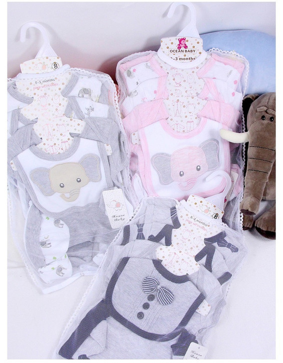 Generic White Sheep 8-Piece Layette Set, collection of baby clothing including shirts and bodysuits with cute animal prints designed for newborns and infants.