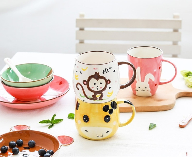 Generic Ceramic Porcelain Tableware Set Monkey, colorful animal-themed mugs and bowls with playful designs on a white table.