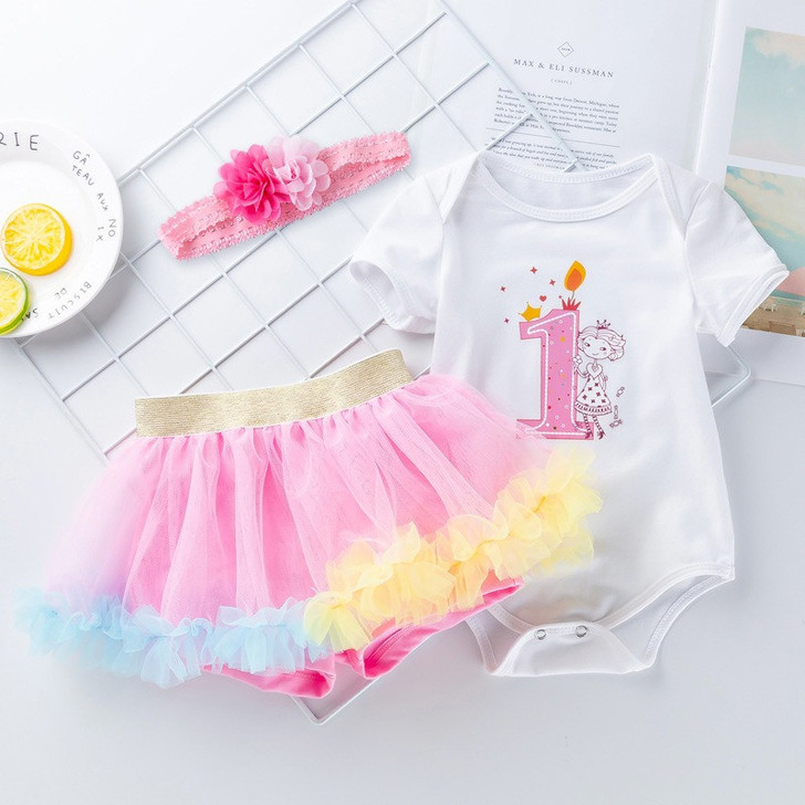 Generic Short Sleeve Romper Tutu Skirt Headband, baby girl's clothing set with a white bodysuit featuring a birthday cake and unicorn design, pink and yellow tutu skirt, and matching pink headband with flower decoration.