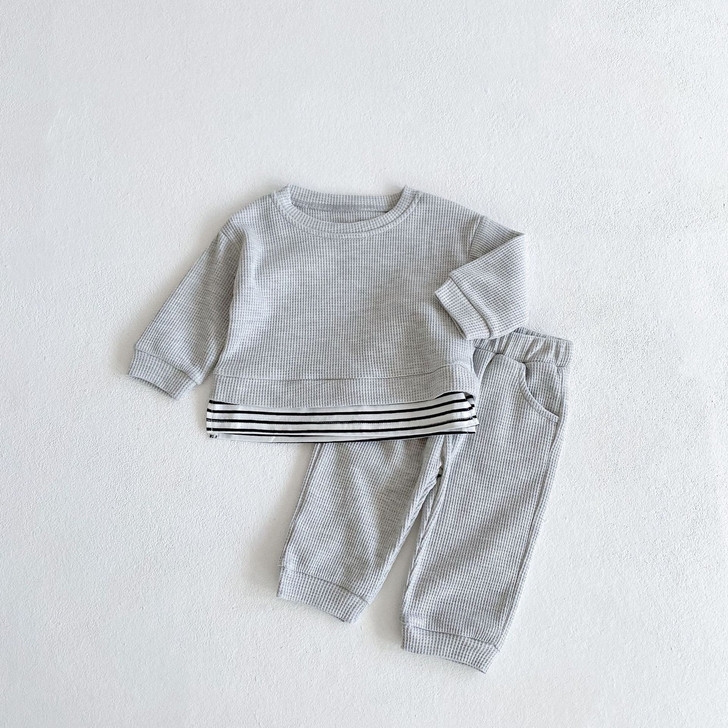 Generic Stitching Grey Round Neck Top & Pants Suit, neatly folded grey casual outfit with striped detail on the top, laid on a white background.