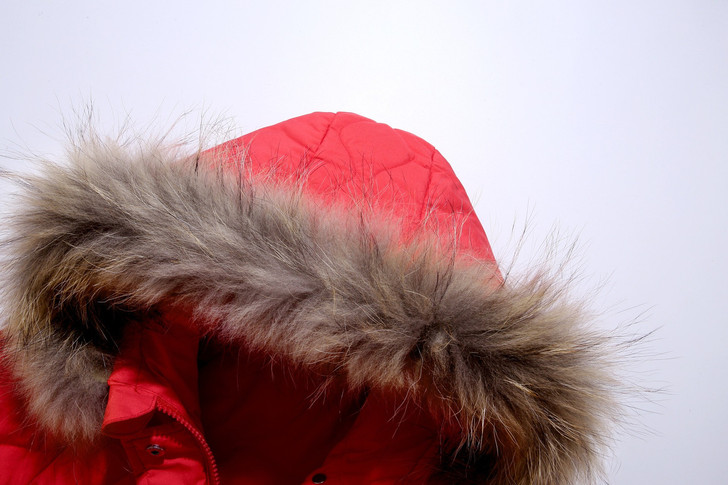 Generic Snowsuit Set Winter Down Snow Suit, close-up of red snow suit with fur-lined hood against plain background.