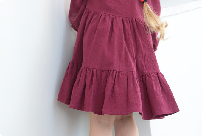Generic Long Sleeve Linen Solid Colour Dress, a knee-length deep red dress with long sleeves and ruffled hem, on a model.