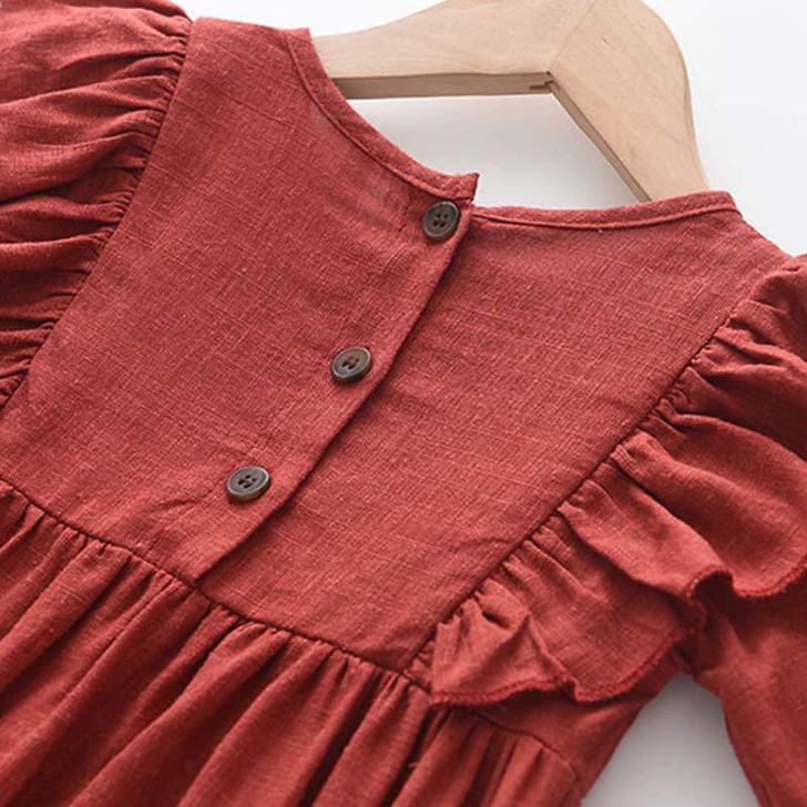 Generic Firebrick Ruffled Long Sleeve Romper Bodysuit, close-up of the red fabric with button details and ruffled sleeves.