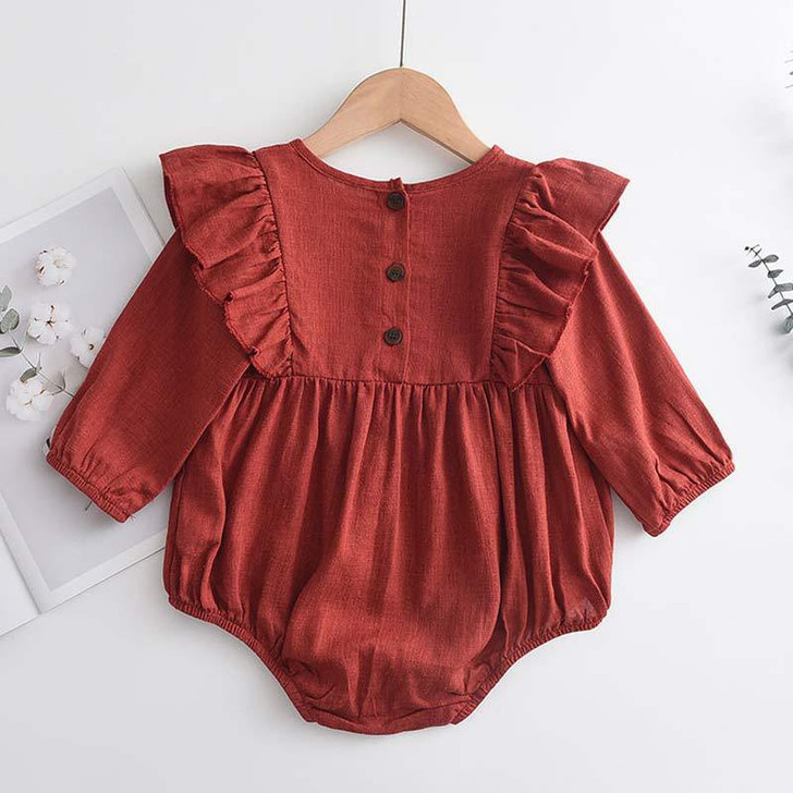 Generic Firebrick Ruffled Long Sleeve Romper Bodysuit, close-up of the stylish red romper with ruffle details on the shoulders and elastic cuffs.
